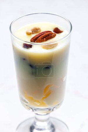Photo for Vanilla custard with nuts and raisins in a glass - Royalty Free Image