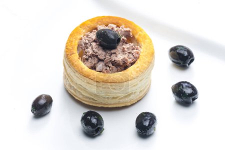 Photo for Puff pastry filled with terrine served with black olives - Royalty Free Image