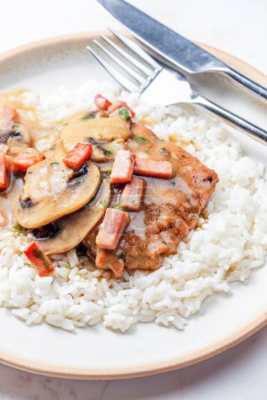Photo for Pork fillet with mushroom sauce and ham served with white rice - Royalty Free Image
