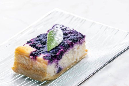 Photo for A piece of blueberry cheesecake on the glass plate - Royalty Free Image