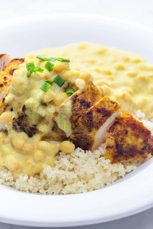 Photo for Chicken breast served with creamy curry chickpea sauce and couscous - Royalty Free Image