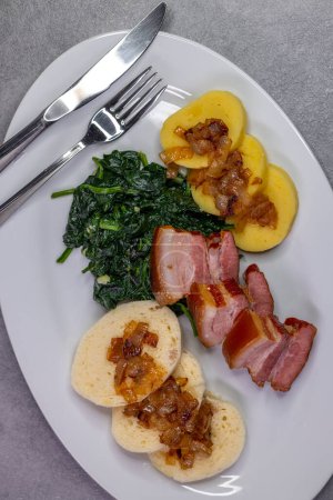 Photo for Smoked flank with potato and bread dumplings and spinach - Royalty Free Image