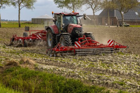 Photo for Tractor during spring work on the field - Royalty Free Image