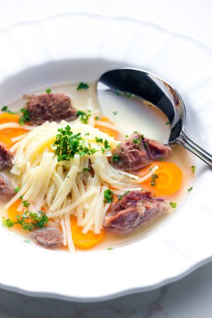 Photo for Beef broth with noodles and carrot - Royalty Free Image