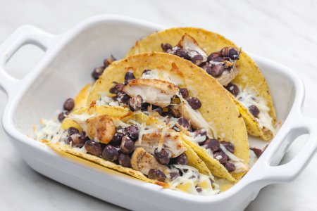Photo for Tacos filled with grilled chicken meat, red beans and grated cheese - Royalty Free Image