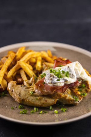 Photo for Typical czech cuisine chicken slice baked with ham and camembert with french fries - Royalty Free Image