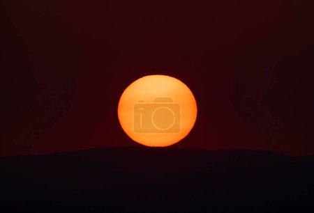 Photo for Sun disc with spots at sunset on a hot summer day - Royalty Free Image