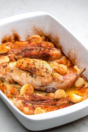 Photo for Baked rabbit leg with garlic and bacon - Royalty Free Image