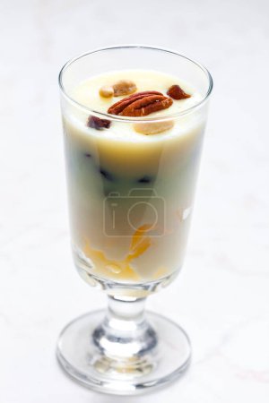 Photo for Vanilla custard with nuts and raisins in a glass - Royalty Free Image