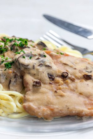 Photo for Pork filet with mushroom sauce served with spatzles - Royalty Free Image