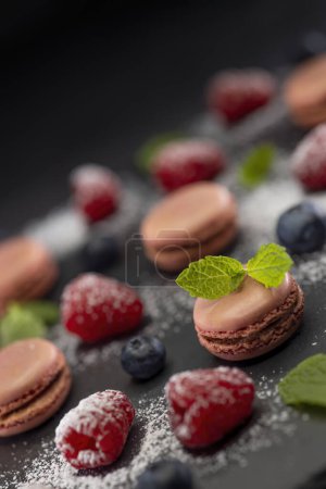 Photo for Macaroons of different colors on a black background - Royalty Free Image