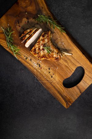 Photo for Pork cutlet with a bone on rosemary and pepper - Royalty Free Image