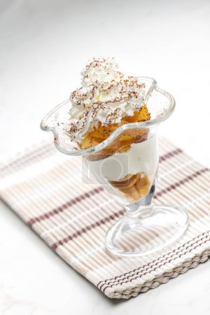 Photo for Ice cream with stewed peach and whipped cream - Royalty Free Image