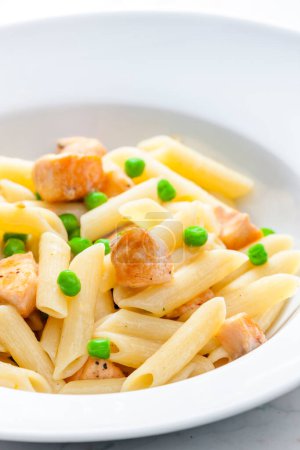 Photo for Pasta penne with salmon and green peas - Royalty Free Image