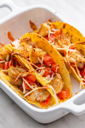 Photo for Tacos filled with grilled chicken meat and tomatoes - Royalty Free Image