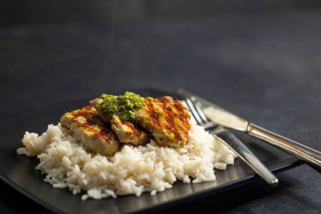 Téléchargez les photos : Grilled poultry meat with pesto served with rice - en image libre de droit
