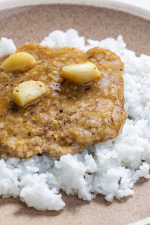 Photo for Pork cutlet with garlic and rice - Royalty Free Image