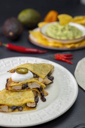 Foto de Quesadilla with chicken meat and beans and guacamole with nachos - Imagen libre de derechos