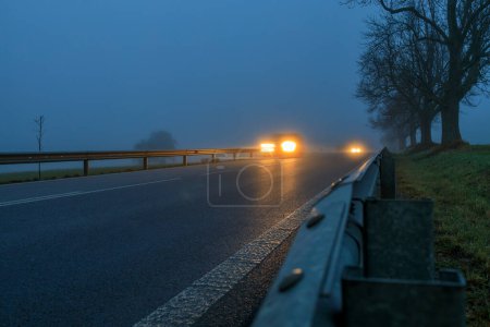 Photo for Lighted cars at dusk on  main road - Royalty Free Image