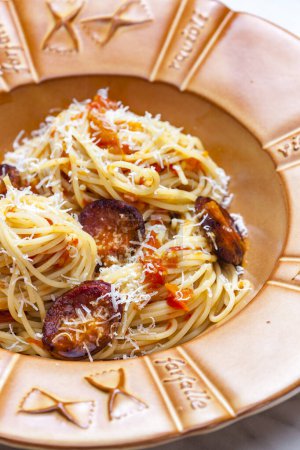 Photo for Spaghetti with sausage and tomatoes and  parmesan cheese - Royalty Free Image