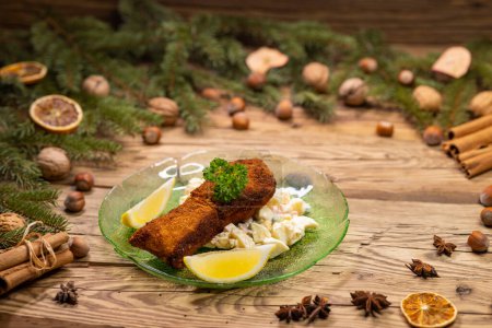 Photo for Christmas fried carp with potato salad - Royalty Free Image