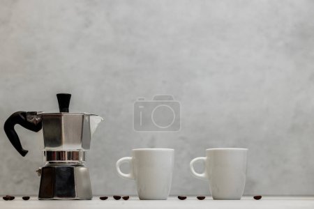 Photo for Metal geyser coffee maker on table with cup - Royalty Free Image