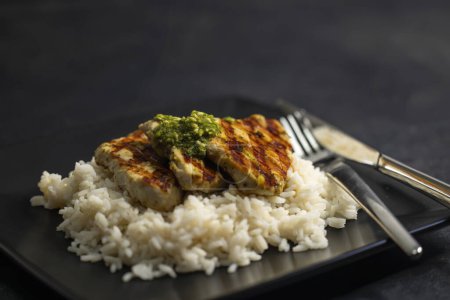 Téléchargez les photos : Grilled poultry meat with pesto served with rice - en image libre de droit
