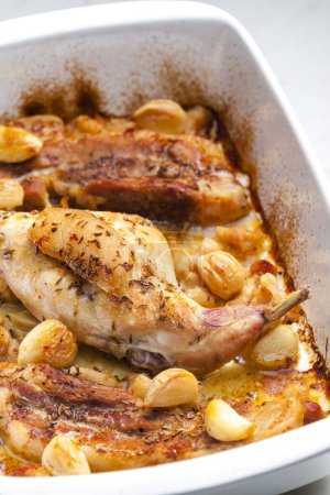 Photo for Baked rabbit leg with garlic and bacon - Royalty Free Image