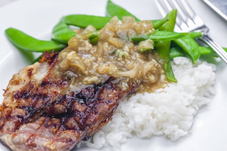 Photo for Pork steak with onion sauce, green beans and rice - Royalty Free Image