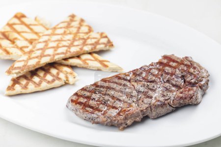 Photo for Beef steak with grilled pita bread - Royalty Free Image