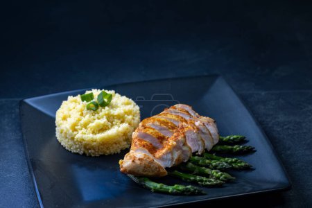 Photo for Green asparagus with grilled chicken fillet and couscous - Royalty Free Image