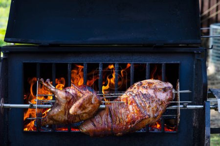 Photo for Roasting pork and turkey on spit - Royalty Free Image