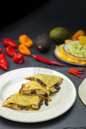 Photo for Quesadilla with chicken meat and beans and guacamole with nachos - Royalty Free Image