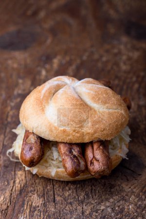 Photo for Nuremberg sausages with sauerkraut in a bun - Royalty Free Image