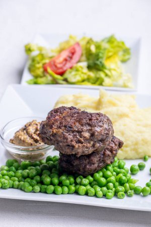 Photo for Bavarian meat loafs with peas - Royalty Free Image