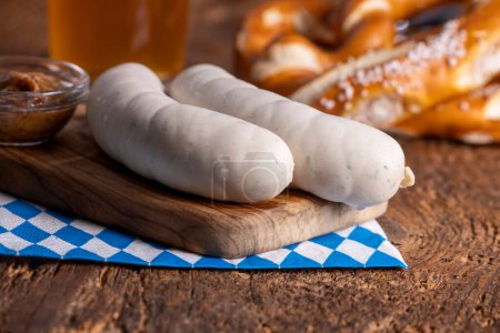 two bavarian white sausages on wood