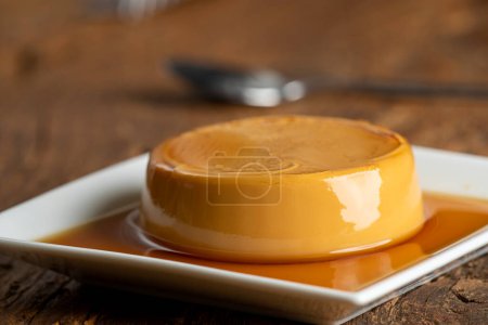 Photo for French flan on dark wood - Royalty Free Image