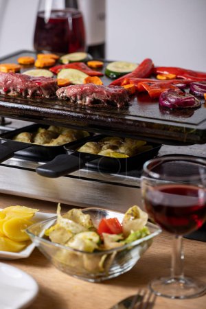 swiss raclette with meat and vegetables