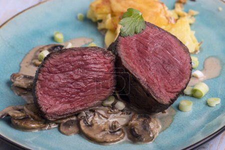 Téléchargez les photos : Steak tranché et gratin de pommes de terre sur une assiette - en image libre de droit