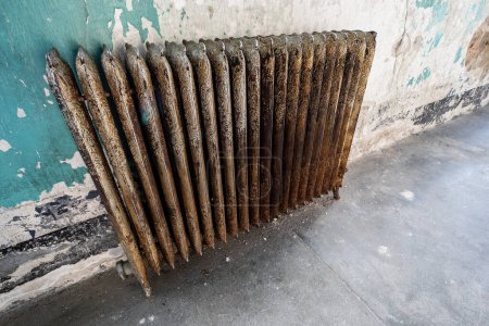 Photo for Antique radiator style heater in a run down building - Royalty Free Image