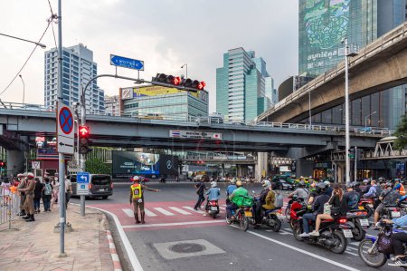 Photo for Bangkok, Thailand - Dec 8, 2022 : The traffic police are working at the Sala Daeng intersection. On Rama IV Road, which is one of the most congested roads. There are both sky train and subway train - Royalty Free Image