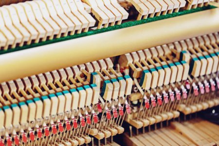 Photo for Close-up shallow focus image of the internal mechanisms of an upright piano. It gives a feeling of luxury, beauty, classic, sophistication, elegance. Image can be use for various topics about  music. - Royalty Free Image