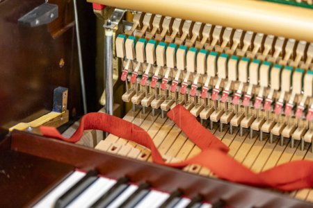 Photo for Shallow focus close-up of tools for tuning the internal mechanisms of an upright piano. Gives a feeling of luxury, classic, luxury, grandeur. Pictures can be used on various topics related to music. - Royalty Free Image