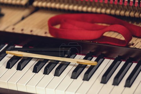 Photo for Shallow focus close-up of tools for tuning the internal mechanisms of an upright piano. Gives a feeling of luxury, classic, luxury, grandeur. Pictures can be used on various topics related to music. - Royalty Free Image