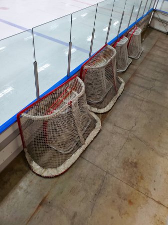 Photo for Hockey nets sitting at the side of a ice rink. - Royalty Free Image