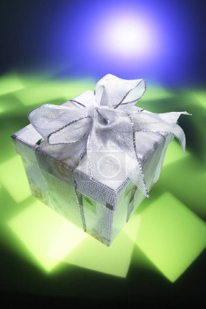 Photo for Gift Parcel on Green and Blue Background - Royalty Free Image