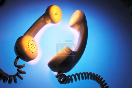 Photo for Telephone Receivers on Blue Background - Royalty Free Image