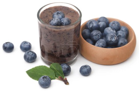 Photo for Fresh blueberries and juice in a glass over white background - Royalty Free Image