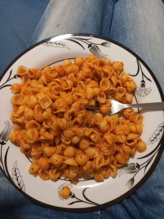 Creamy macaroni pasta on a plate with a fork