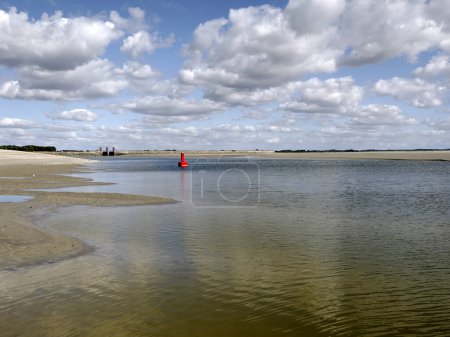 Photo for Beach and red buoy at low tide of Le Crotoy a commune in the Somme department in Hauts-de-France in northern France - Royalty Free Image
